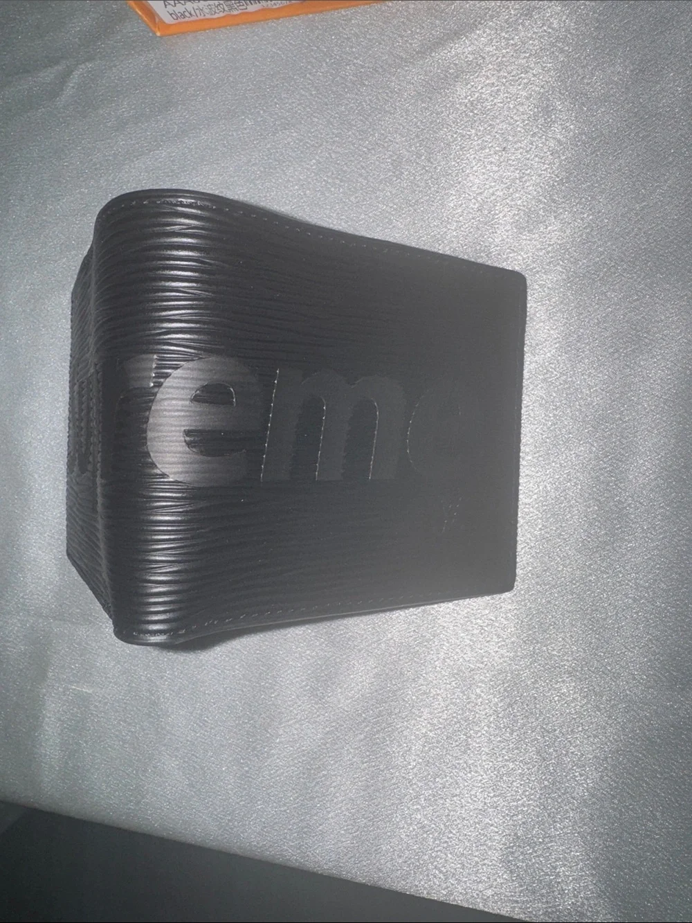 Louis Vuitton x Supreme Epi leather wallet featuring an embossed Supreme logo!